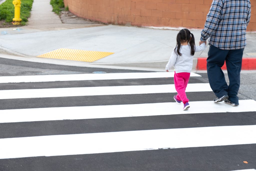 photo of pedestrians walking on crosswalk